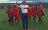 The author shows off his jumping ability to warriors in a Maasai village.