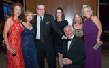 Bill Smith of Virtuoso, kneeling, with (from left) Dondra Ritzenthaler of Celebrity Cruises, Vicki Freed of Royal Caribbean International, Alex Sharpe of the Signature Travel Network, Lara Leibman of Frosch, Paula Hayes of Globus and Tracy Sedlak of Club Med.