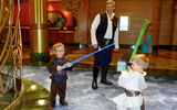 Rick Ronchetti, a passenger from North Caldwell, N.J., plays the role of Han Solo while his sons, Logan 4, as Luke, and Colin 7, as Anakin, battle with lightsabers.