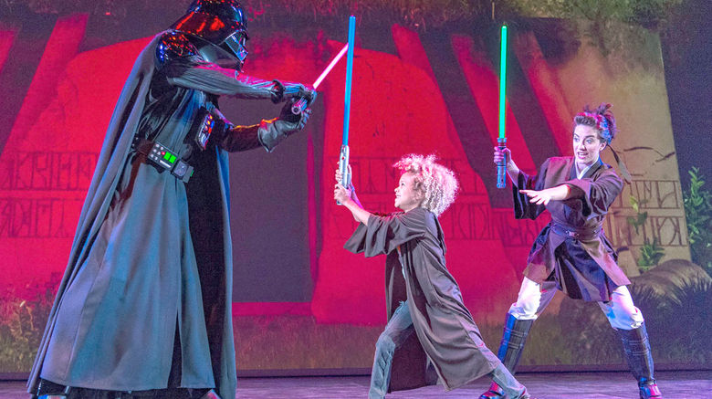 During Disney Cruise Line's first Star Wars Day at Sea aboard the Disney Fantasy, passengers -- many decked out in impressive and realistic Star Wars costumes -- took part in trivia challengers, deck parties, special menus and meet-and-greets, among other activities. Pictured here, is ''Jedi Training: Trials of The Temple,'' where kids learn the ways of the Jedi and put their skills to the test in a final battle with the Sith Lord, Darth Vader.