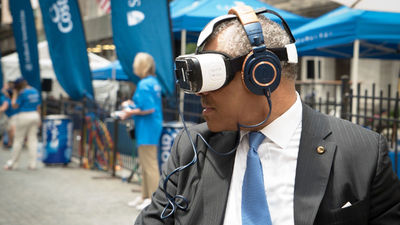 Carnival Corp. CEO Arnold Donald wearing a Samsung Gear VR headset.