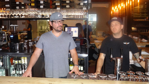 Rooster & The Till co-owner Ty Rodirguez, left, stands with an employee in front of the restaurant’s open bar and kitchen. Rooster & The Till co-owner Ty Rodirguez, left, stands with an employee in front of the restaurant’s open bar and kitchen.
