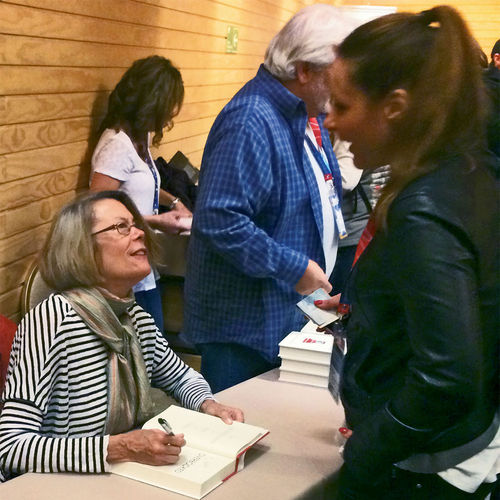 Elizabeth Becker signs a copy of “Overbooked” in Puerto Varas, Chile.