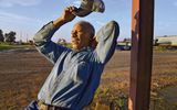 Ernest Cox, a farmer in the Mississippi Delta, near Marvel, Ala., kicks back in the early evening after a long day at harvest time.