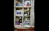 The windows of this old house in Greenville, Miss., are filled with pictures of President Barack Obama.