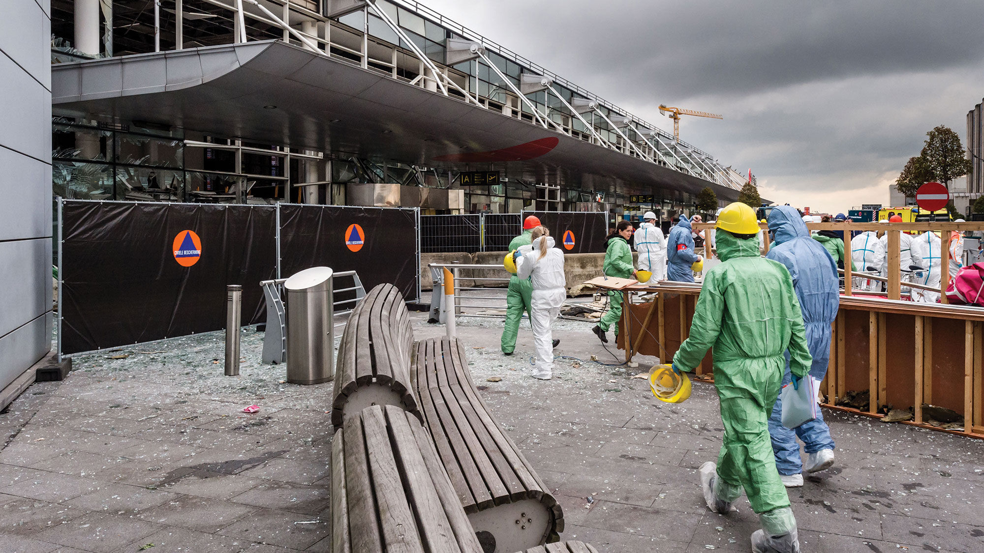 Forensic officers work in front of the damaged Zaventem Airport terminal in Brussels on March 23.