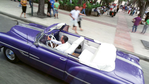 A vintage car driven through the streets of Old Havana. A vintage car driven through the streets of Old Havana.