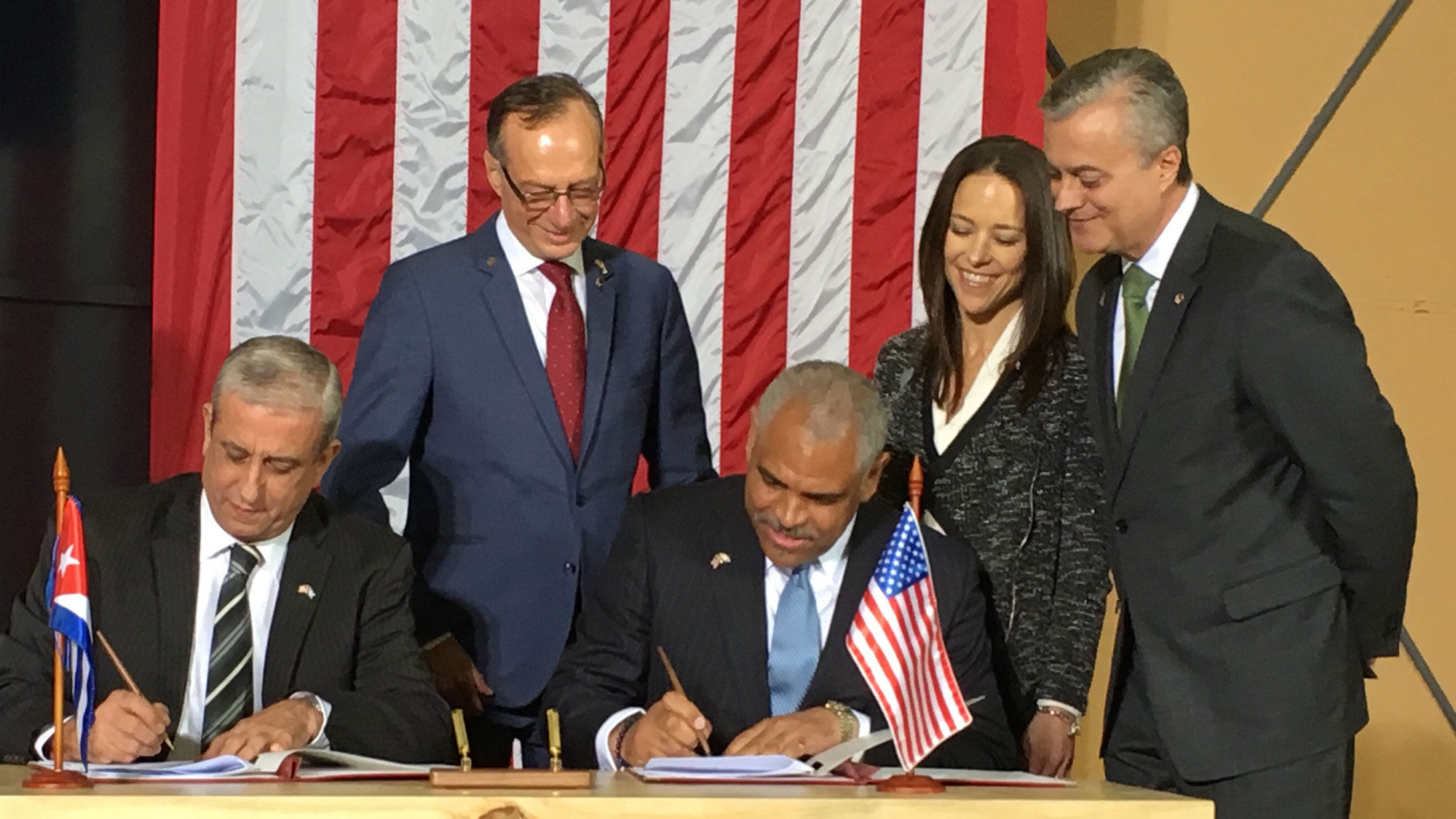 Cuba president of maritime operations Nelson Torres (left) and Carnival Corp. CEO Arnold Donald sign a deal allowing Cuba cruises from the United States. From left, Carnival Corp. senior vice president of global port development Giora Israel, Fathom president Tara Russell and Carnival Corp. general counsel Arnaldo Perez look on.