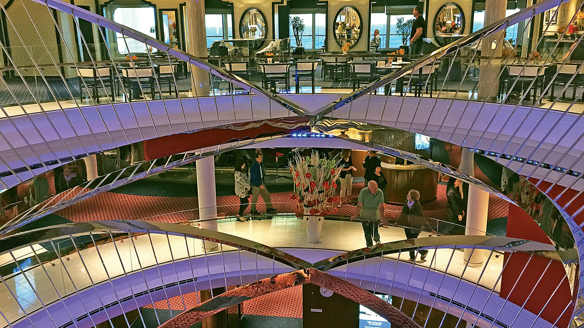 The Koningsdam's circular atrium is illuminated from the top by a faux skylight.
