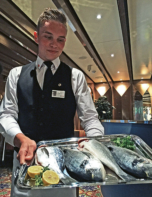 A waiter at Sel de Mer displays sea bream bought fresh in the local market that day. A waiter at Sel de Mer displays sea bream bought fresh in the local market that day.