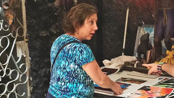 Agent Denise Kahoud of Pisa Brothers in New York looks through prints at the Callejon Hamel community art project in Havana. Agent Denise Kahoud of Pisa Brothers in New York looks through prints at the Callejon Hamel community art project in Havana.