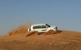 Dune bashing in a Land Cruiser with desert safari operator Travco.