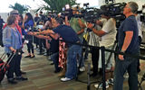 Media throngs interview passengers in the Port of Miami’s Terminal J as they prepare to board the Fathom's Adonia.