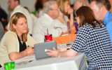 Daniela Harrison, left, a frontline agent at Avenues of the World Travel, meets with suppliers during GTM West's one-on-one appointments.