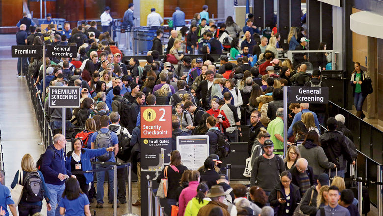 Travelers wait in line for security screening at Seattle-Tacoma Airport in March. Flyers will likely face massive security lines at airports across the country this summer.