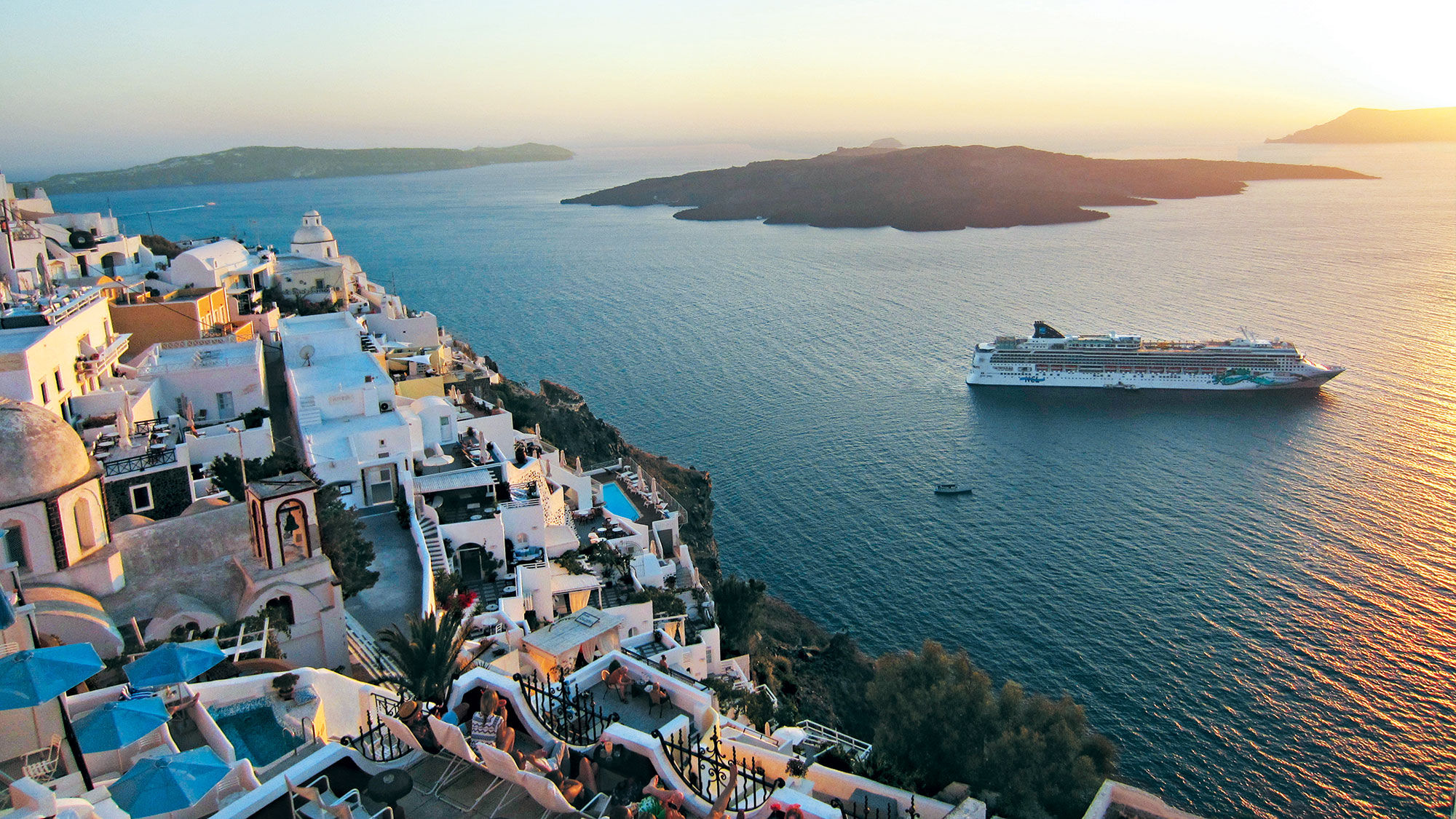 Norwegian Cruise Line has seen a drop in North American customers for its European cruises such as this one off the coast of Santorini.