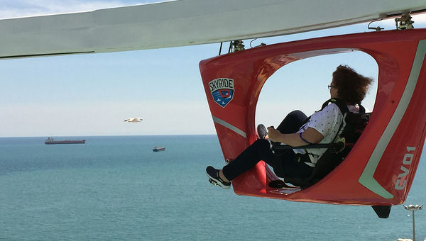 SkyRide vehicles travel on a track 150 feet above the water.
