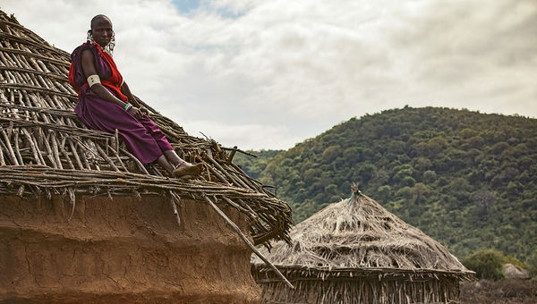 One of the Maasai engineers sits atop a home for which she installed a cookstove as part of the Maasai Clean Stoves Project, supported by G Adventures. One of the Maasai engineers sits atop a home for which she installed a cookstove as part of the Maasai Clean Stoves Project, supported by G Adventures.