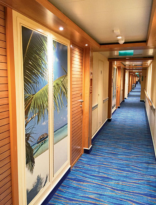 The stateroom corridors on Carnival Vista feature floor-to-ceiling photo panels.