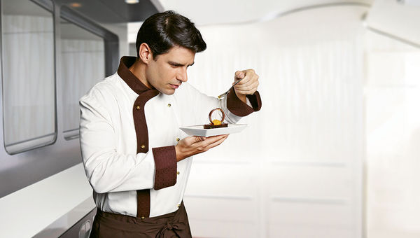 One of Etihad’s In-Flight Chefs puts the finishing touches on a dessert. One of Etihad’s In-Flight Chefs puts the finishing touches on a dessert.