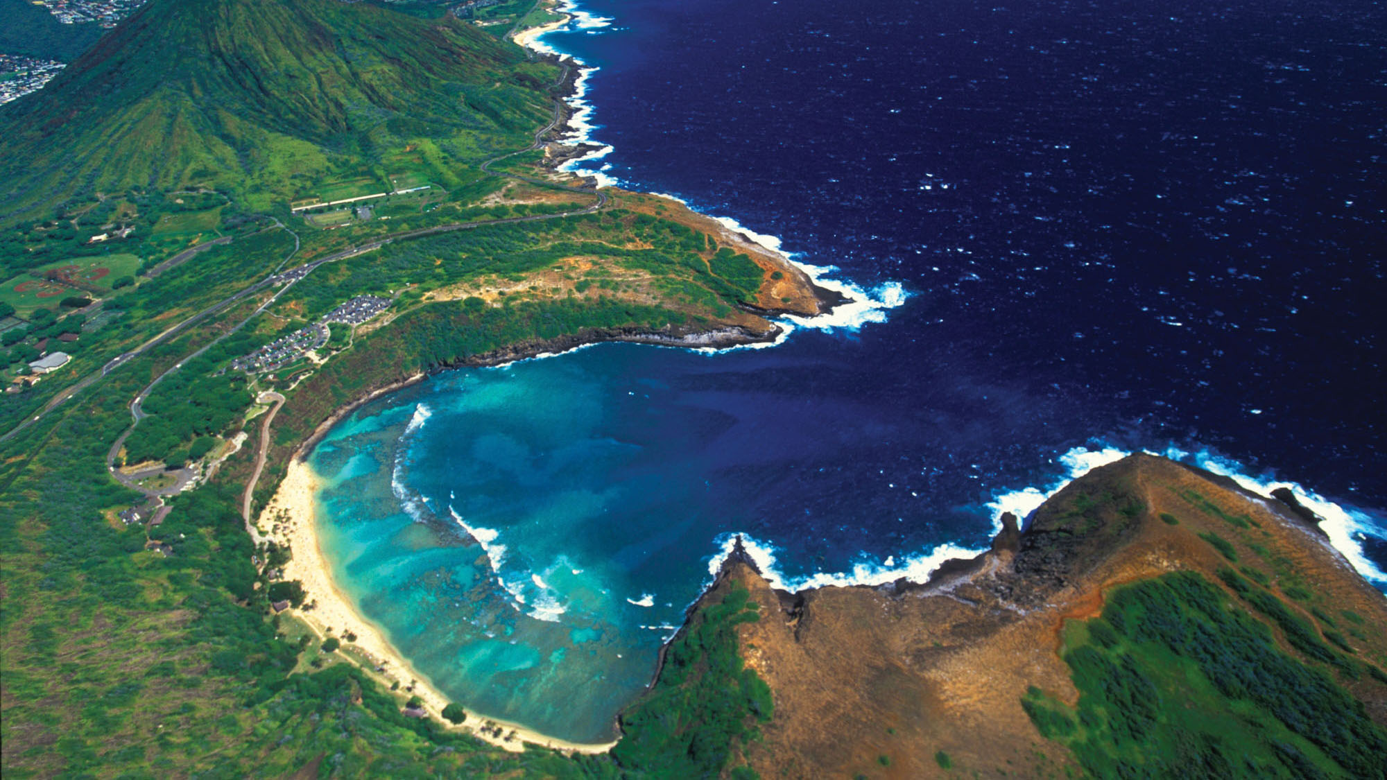 The beach at Hanauma Bay Nature Preserve fronts Oahu’s most popular coral reef snorkeling site.