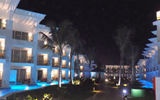 Resort accommodations bathed in blue light at night.