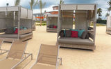 Canopy beds on the golden-sand beach.