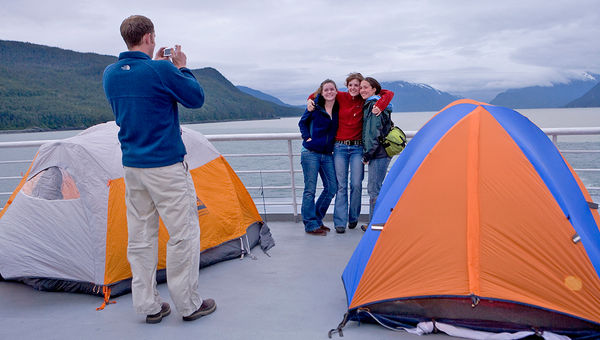 Setting up a tent on the upper deck affords passengers with prime viewing of the passing scenery. Setting up a tent on the upper deck affords passengers with prime viewing of the passing scenery.