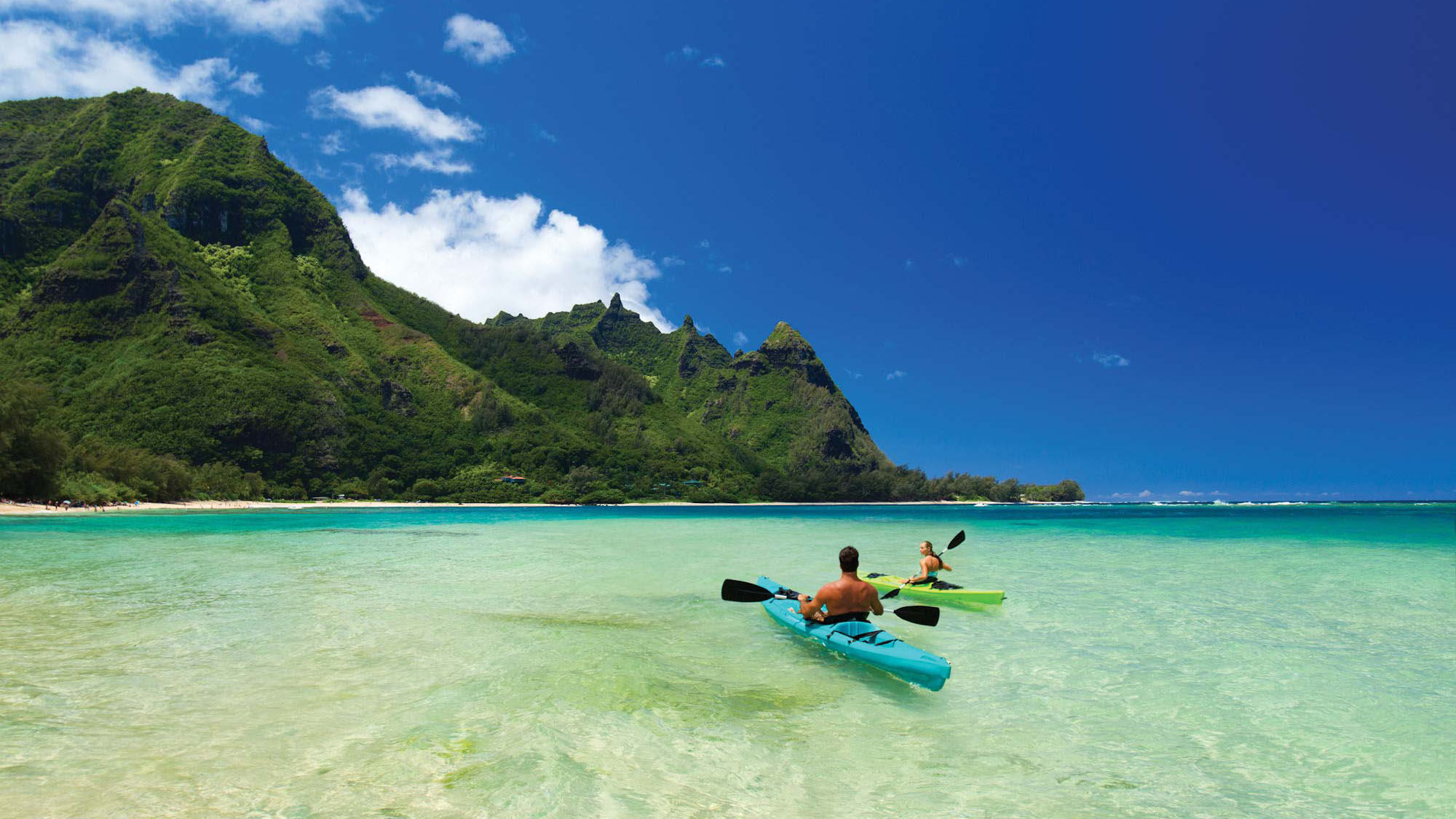 Kayakers paddle along Kauai’s North Shore in Hanalei Bay.