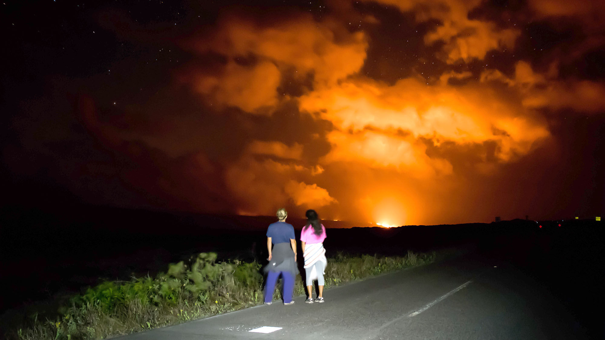 Visitors view new lava flow from the end of Chain of Craters Road within Hawaii Volcanoes National Park.