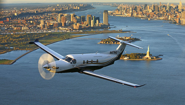 A Tradewind Aviation shuttle, a Pilatus PC-12, soars over New York. A Tradewind Aviation shuttle, a Pilatus PC-12, soars over New York.