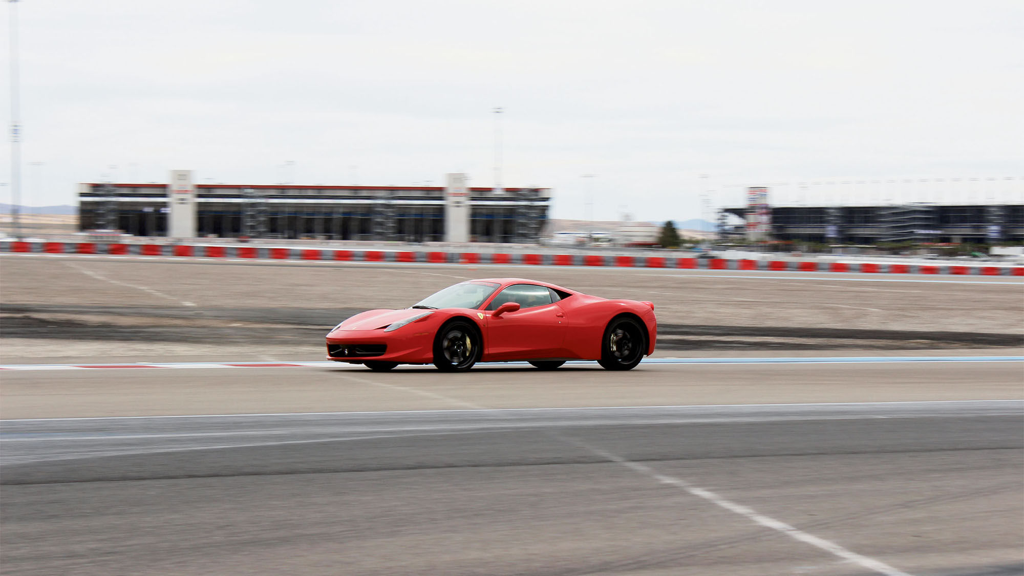 An Exotics Racing customer takes a Ferrari 458 for a spin around the company’s track at the Las Vegas Motor Speedway.