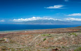 A view of Lanai's Shipwreck Beach coastline with the island of Molokai in the distance.