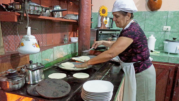 In Costa Rica, Dona Mara Rojas Perez cooks tortillas, handmade by a tour group during an in-home cooking class. In Costa Rica, Dona Mara Rojas Perez cooks tortillas, handmade by a tour group during an in-home cooking class.