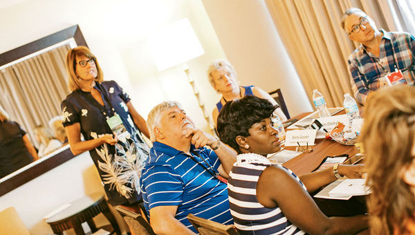 During a boardroom breakout session, Peggy McNeil of Seabourn speaks with travel agent attendees. During a boardroom breakout session, Peggy McNeil of Seabourn speaks with travel agent attendees.