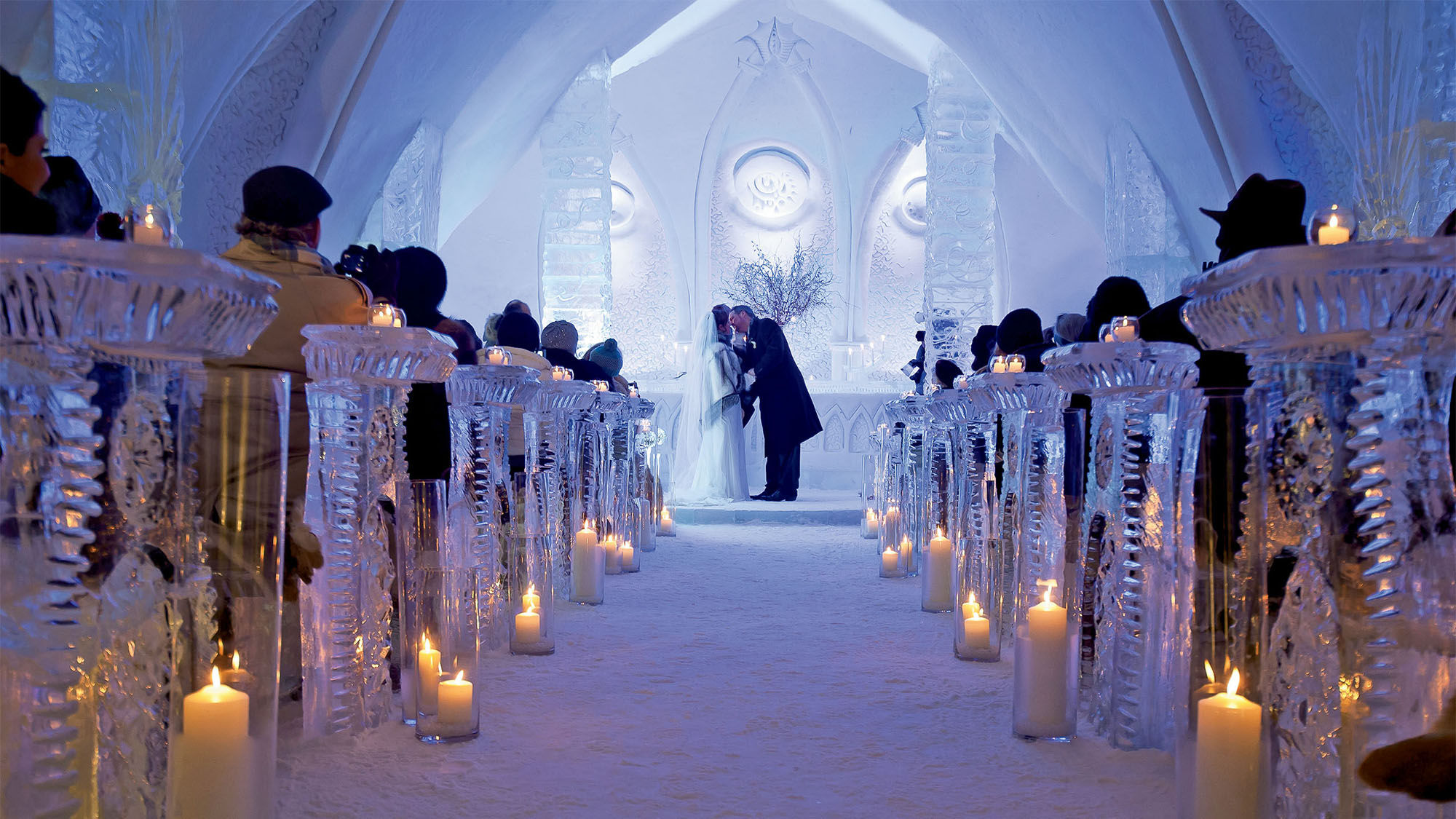 The ice chapel at the Hotel de Glace holds up to 65 guests, providing blankets and wraps as they sit on fur-covered ice pews.