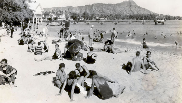 Waikiki beachgoers relax near the Moana Surfrider, around 1925.