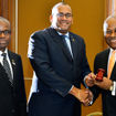 Obie Wilchomble, at right, takes the gavel from outgoing CTO chairman Richard Sealey to begin his second term as chair in 2016. At left is Hugh Riley, who at the time was secretary general of the organization.