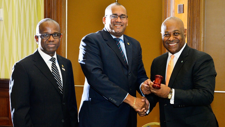 Obie Wilchomble, at right, takes the gavel from outgoing CTO chairman Richard Sealey to begin his second term as chair in 2016. At left is Hugh Riley, who at the time was secretary general of the organization.