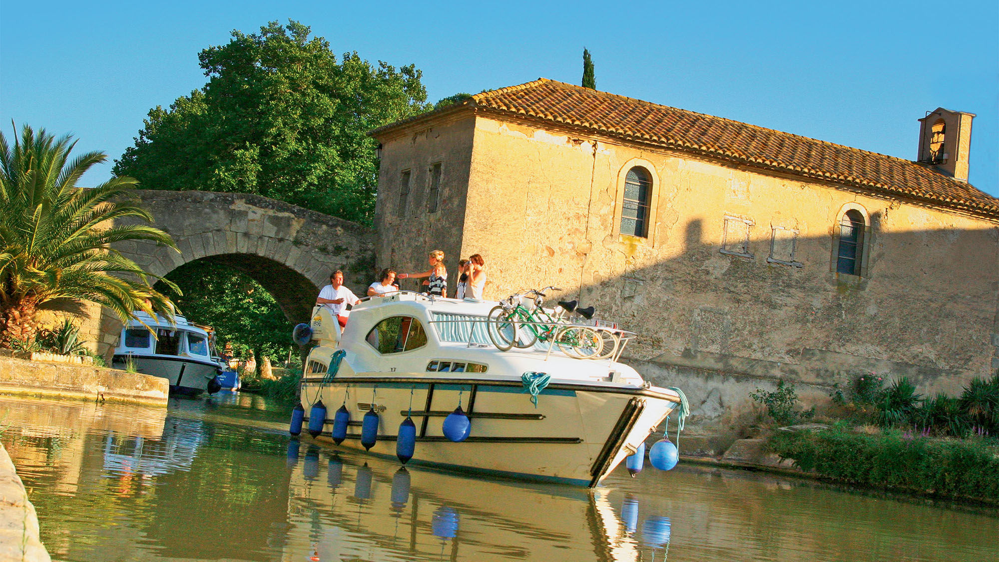 One of the stops the author enjoyed on the LeBoat itinerary on the Canal du Midi was the tiny town of Le Somail, which features several ivy-covered alfresco restaurants.
