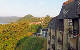 The utilitarian architecture of the communist-era Hotel Lepenski Vir contrasts sharply with the Danube and the red roofs of the town Donji Milanovach below it.