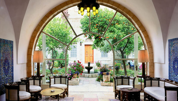 The entrance and patio of the American Colony Hotel, an 86-room property in Jerusalem with lush gardens. The entrance and patio of the American Colony Hotel, an 86-room property in Jerusalem with lush gardens.