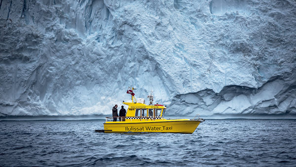 A water taxi sails in front of an iceberg near the Ilulissat Icefjord in Greenland. Sarah Woodall of Visit Greenland said some travelers are visiting to see the glaciers before they’re permanently altered. A water taxi sails in front of an iceberg near the Ilulissat Icefjord in Greenland. Sarah Woodall of Visit Greenland said some travelers are visiting to see the glaciers before they’re permanently altered.