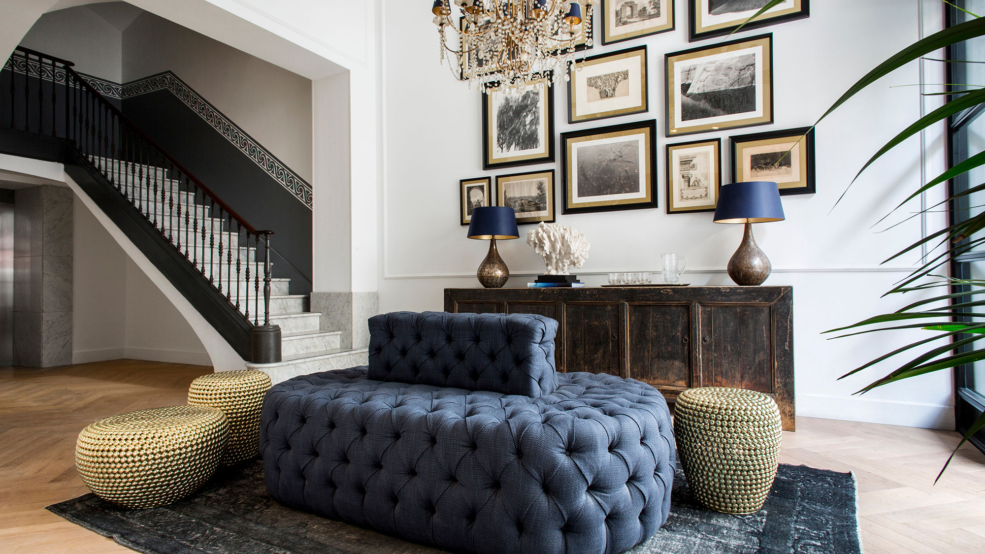 In the hotel's lobby, the original iron staircase mixes with such modern elements as an industrial-style front door and chic chandeliers.