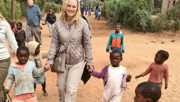 Patricia Hearst Shaw walks hand in hand with local children during a visit to the Zambian village of Nakatindi, a stop on Abercrombie & Kent’s President’s Trip itinerary. Patricia Hearst Shaw walks hand in hand with local children during a visit to the Zambian village of Nakatindi, a stop on Abercrombie & Kent’s President’s Trip itinerary.