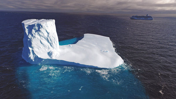 The Crystal Serenity passes by an iceberg in Canada’s Bellot Strait, along the Northwest Passage.