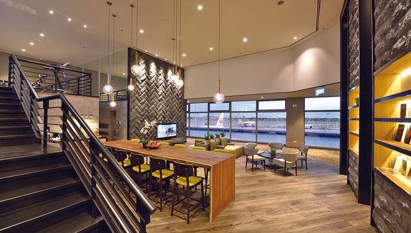 The lounge at the 70-room Aerotel “airport-transit hotel” at Singapore Changi Airport features a view of the airport’s runway.