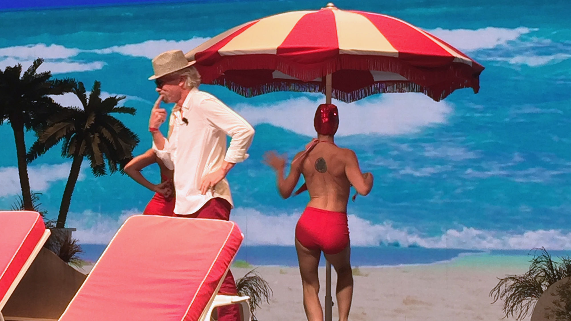Richard Branson, accompanied by dancers, makes his entrance during Tuesday's Virgin Voyages event.