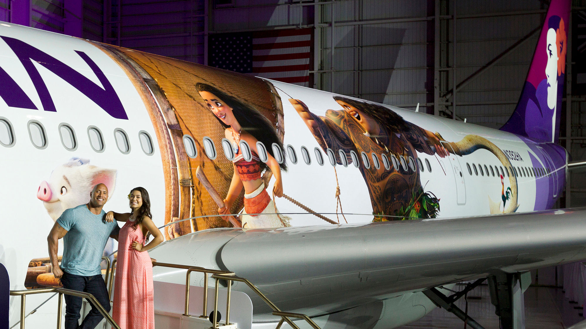 "Moana" stars Dwayne Johnson and Auliʻi Cravalho pose in front Hawaiian Airlines' new livery design.