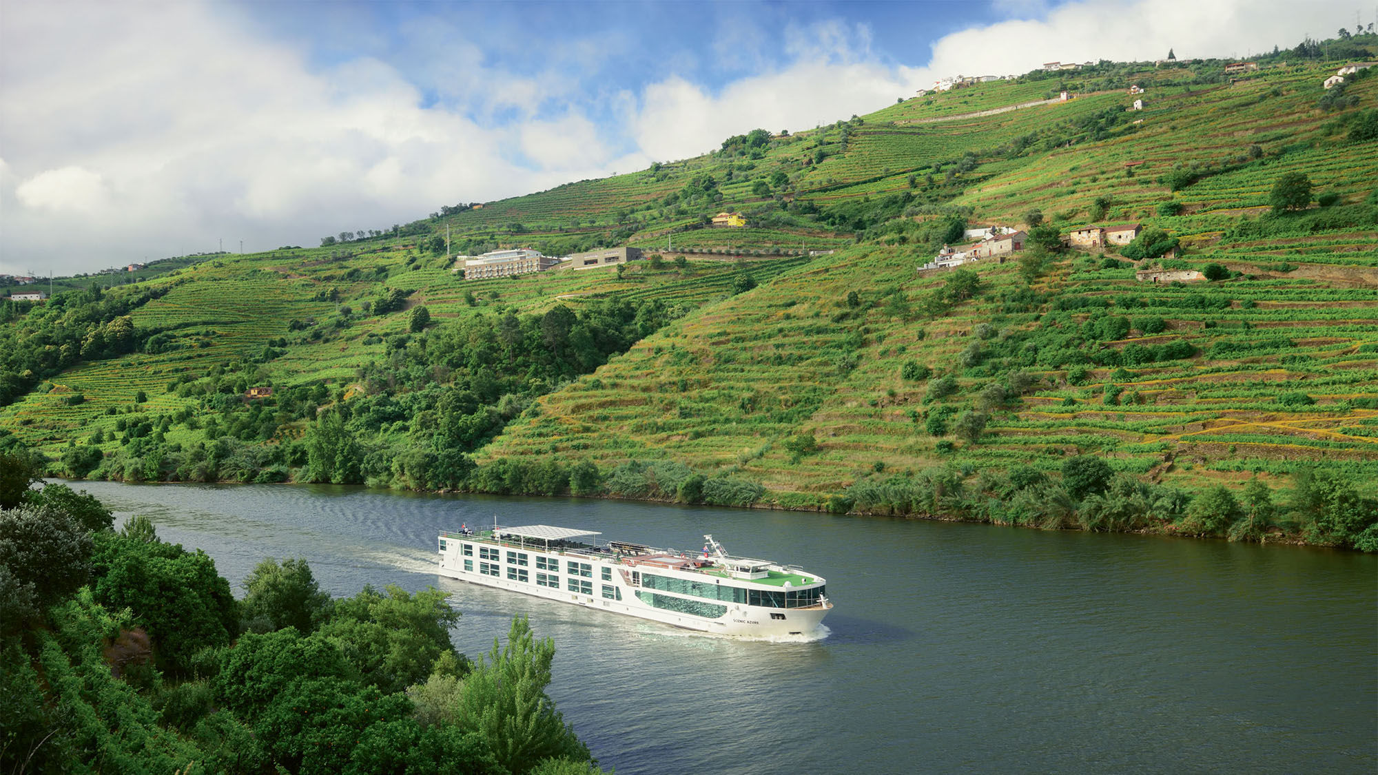 The 48-cabin Scenic Azure sails past the northern Portugal town of Peso da Regua on the Douro River.